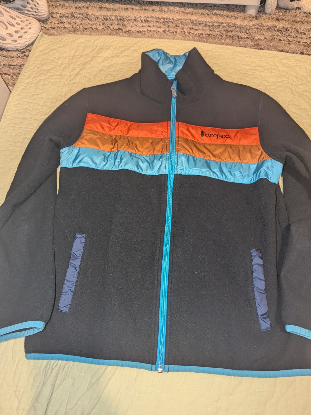 cotopaxi Women's Black Fleece Jacket with Orange, Gold and Light Blue Accents